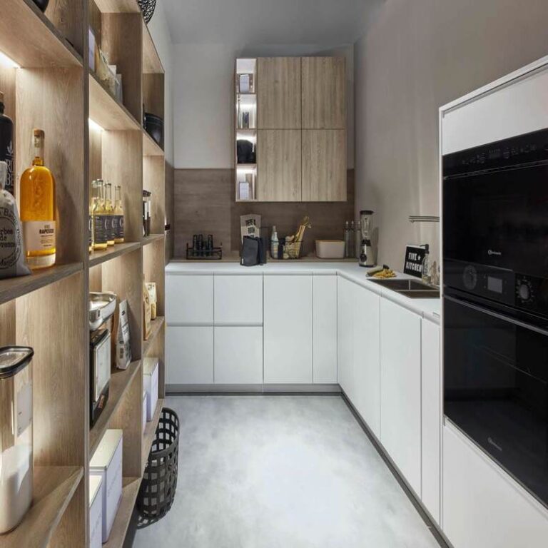 Moderne weiße Küche mit Hochschränken, Holzregal und schwarzen Einbaugeräten – Küche kaufen Mannheim